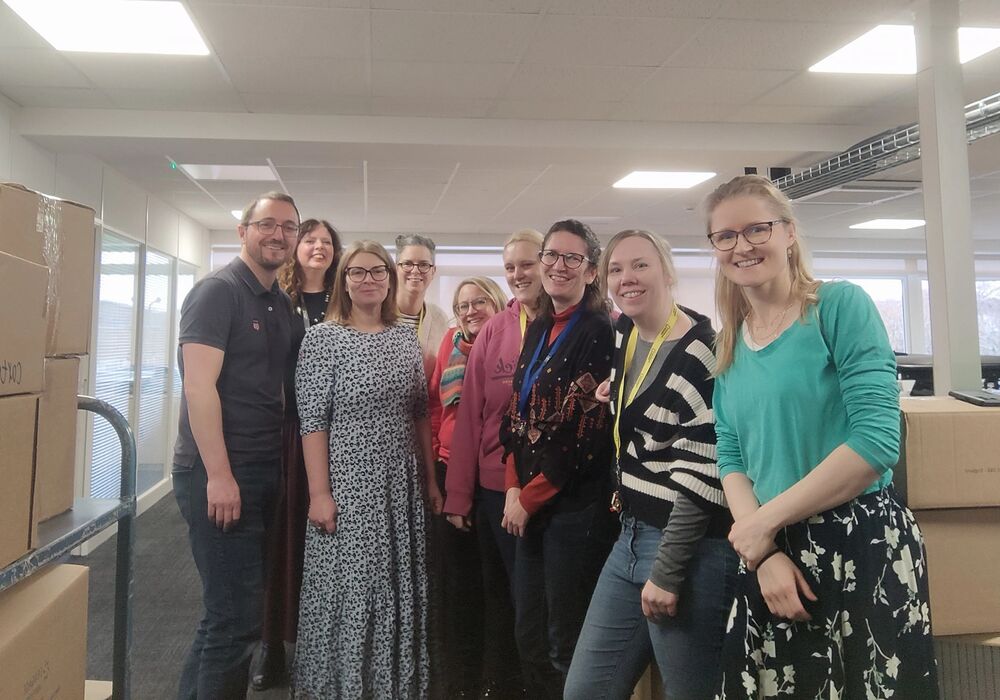 Jess and Dan alongside other members of the ELT team who helped prepare the books for donation