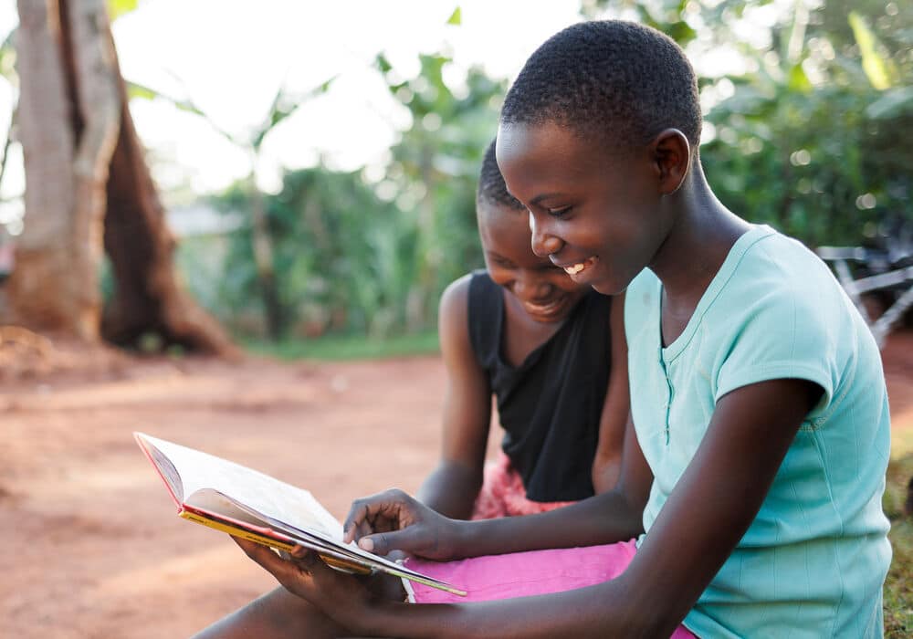 The campaign will provide more books to young readers in communities, like these girls in rural Uganda. (c) Jjumba Martin