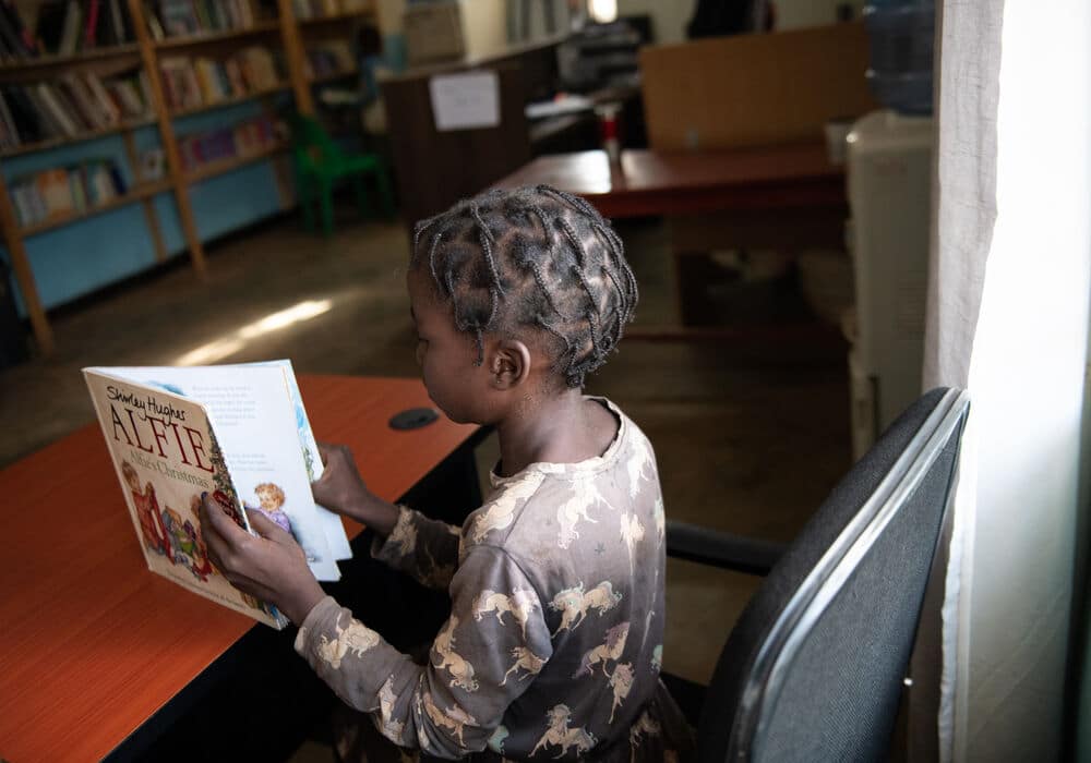 A girl reading a book in the library