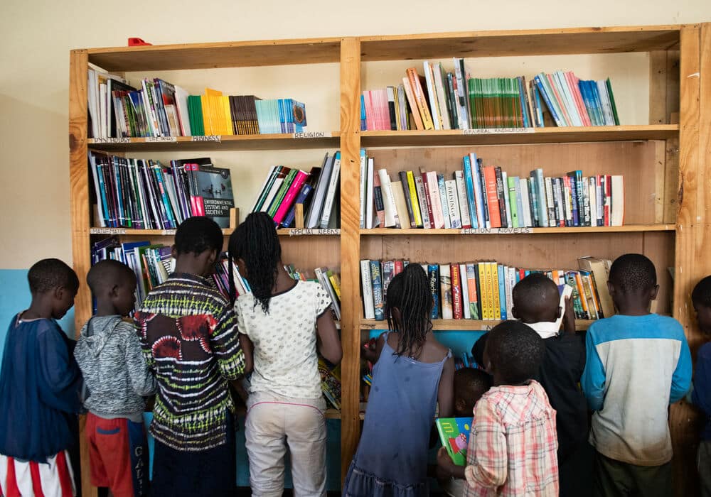 Children looking for books in the library