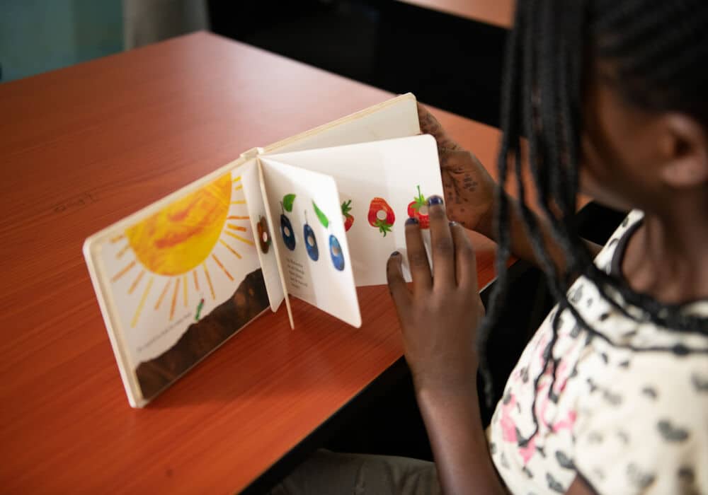 A girl looking at a book in the library
