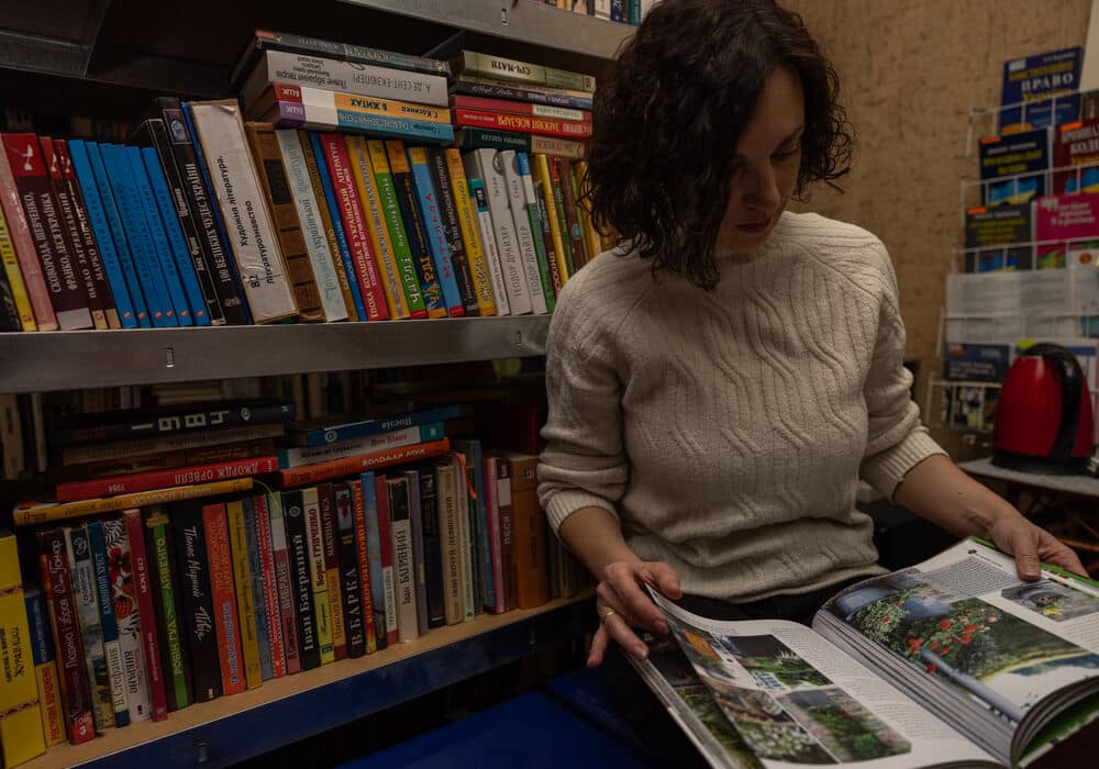 Iryna reading a book in the library