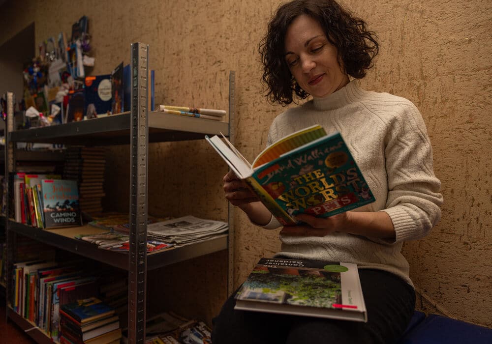 Iryna looking at books in the library