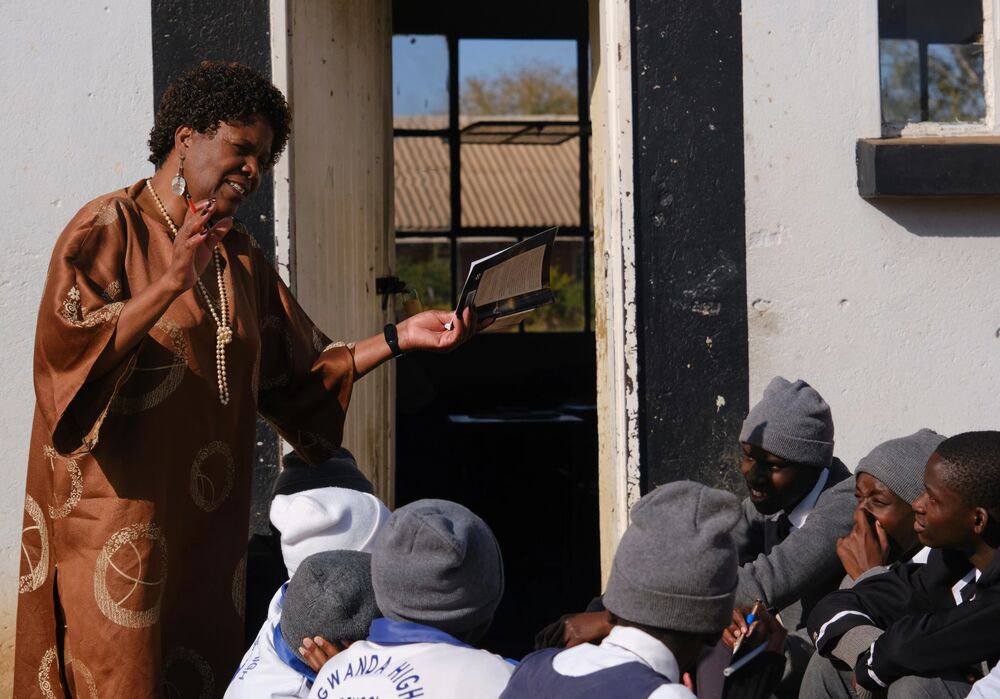 Cynthia reading to students outside her classroom