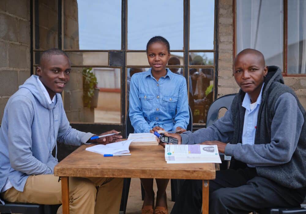 Tariro at home with her brother and father
