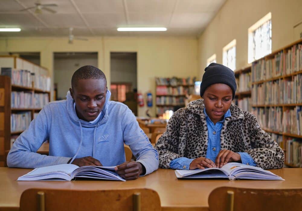 Tanaka and Tariro studying in the library